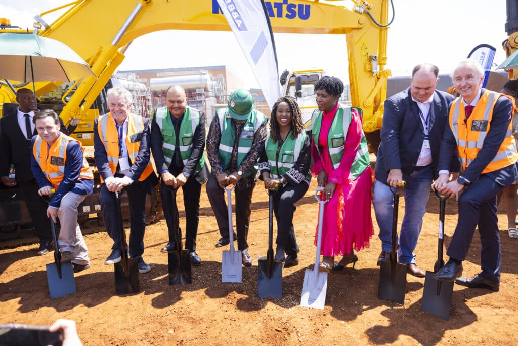 Team members break ground at a new malt plant construction site, marking a major milestone in expanding malt production capacity.