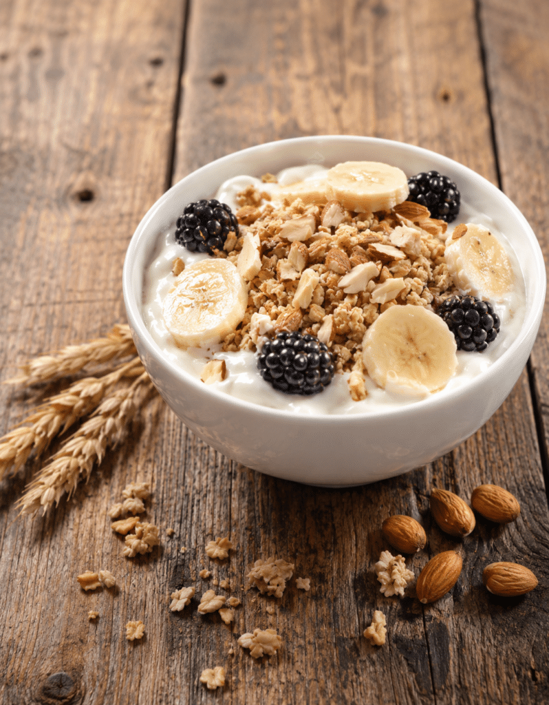 A yogurt bowl topped with granola, fruit, and nuts demonstrates nutritious clean label food production using natural malt-based ingredients.